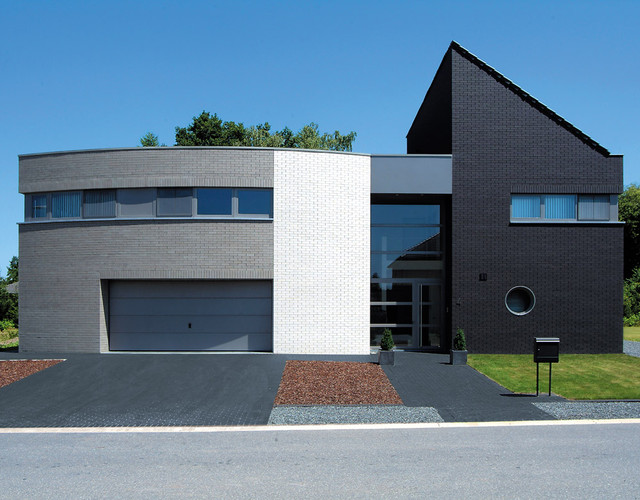 A residential building made of gray and black smooth shaded Faro brick
