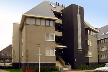 A residential building made of gray shaded and shaded smooth Faro brick